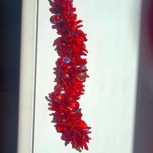 Beautiful glass beaded bracelets. Red or purple.Run very snug on your wrist.